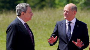 German Chancellor Olaf Scholz, right, talks with Prime Minister of Italy Mario Draghi, left, during a photo at the G7 Summit in Elmau, Germany, Sunday, June 26, 2022, during an arrival ceremony. (AP Photo/Susan Walsh, Pool)