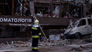 Firefighters work at the scene of a residential building following explosions, in Kyiv, Ukraine, Sunday, June 26, 2022. Several explosions rocked the west of the Ukrainian capital in the early hours of Sunday morning, with at least two residential buildings struck, according to Kyiv mayor Vitali Klitschko. (AP Photo/Nariman El-Mofty)