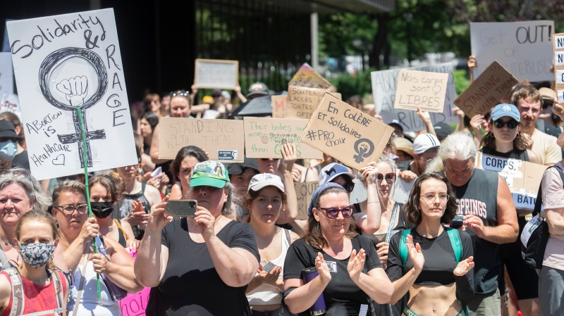 People take part in a protest to denounce the United States Supreme Court's decision to overturn the law that provided the constitutional right to abortion for almost 50 years, in Montreal, Sunday, June 26, 2022. THE CANADIAN PRESS/Graham Hughes