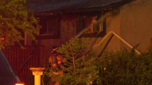 Firefighters douse flames at a home in west Edmonton on Saturday, June 25, 2022 (CTV News Edmonton/Sean McClune).