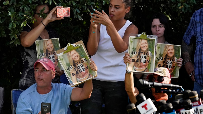 In this Wednesday, Oct. 20, 2021, file photo, Supporters of Gabby Petito hold up photos of Gabby after a news conference Wednesday, Oct. 20, 2021, in North Port, Fla. (AP Photo/Chris O'Meara, File)