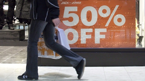 A shopper walks past a sign at Bayshore Shopping Centre in Ottawa on Wednesday, Dec. 23, 2009. (Pawel Dwulit / THE CANADIAN PRESS)