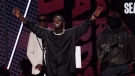 Sean "Diddy" Combs accepts the lifetime achievement award at the BET Awards, June 26, 2022, at the Microsoft Theater in Los Angeles. Babyface and Kanye West, also known as Ye, look on from back left. (AP Photo/Chris Pizzello)