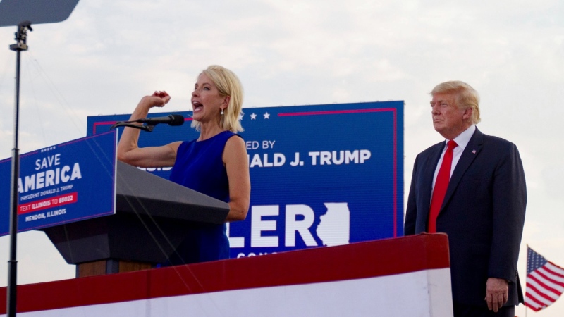 U.S. Rep. Mary Miller, of Illinois, speaks as former U.S. President Donald Trump stands behind her on stage at a rally at the Adams County Fairgrounds in Mendon, Ill., on June 25, 2022. (Mike Sorensen / Quincy Herald-Whig via AP) 