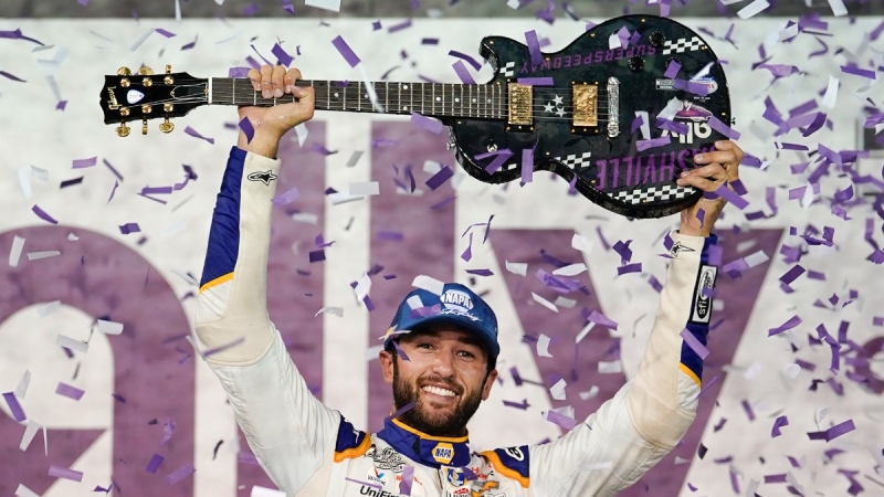 Chase Elliott holds the guitar presented to him after winning a NASCAR Cup Series auto race, June 26, 2022, in Lebanon, Tenn. (AP Photo/Mark Humphrey)