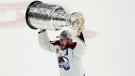 Colorado Avalanche center Nathan MacKinnon lifts the Stanley Cup after the team defeated the Tampa Bay Lightning 2-1 in Game 6 of the NHL hockey Stanley Cup Finals on Sunday, June 26, 2022, in Tampa, Fla. (AP Photo/John Bazemore)