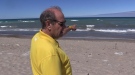 Standing on Station Beach in Kincardine, Ont. on June 27, 2022, Mike Walsh points out where he spotted the body of drowning victim, Aleem Ramji, in September 2020. (Scott Miller/CTV News London)