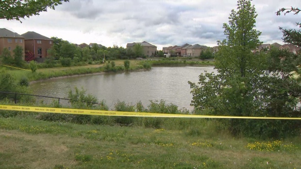 Police tape is seen around a Brampton pond where a missing woman has been found dead.