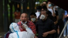 Residents line up to get a throat swab at a testing site in Beijing, China, on June 28, 2022. (Andy Wong / AP)