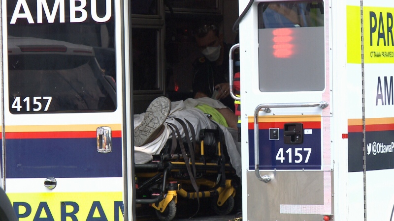 A person is loaded into an Ottawa paramedic ambulance after being injured on the fifth floor roof of a construction site on Cummings Avenue, requiring a rope rescue to get them down to the ground. June 28, 2022. (Jim O'Grady/CTV News Ottawa)