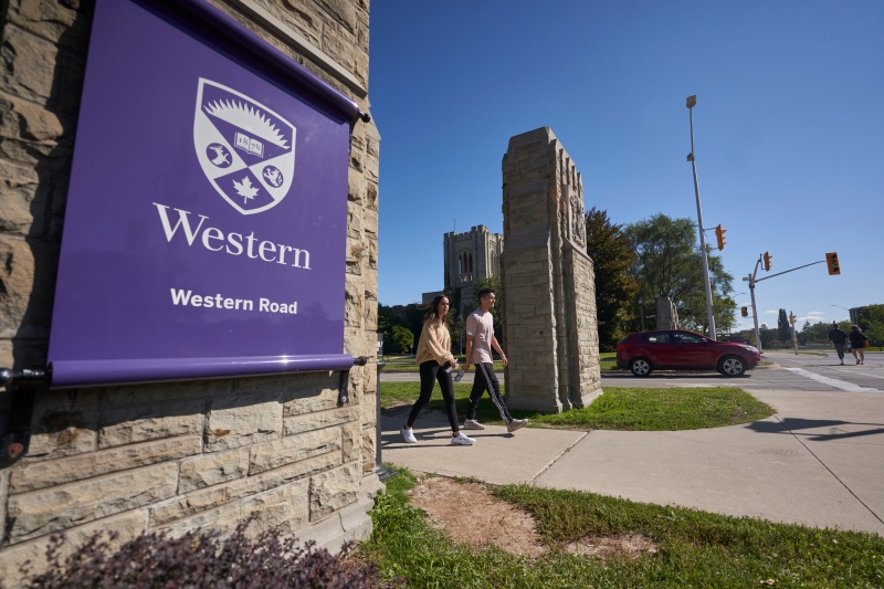 Students walk across campus at Western University in London, Ont., Saturday, Sept. 19, 2020. (THE CANADIAN PRESS/Geoff Robins)