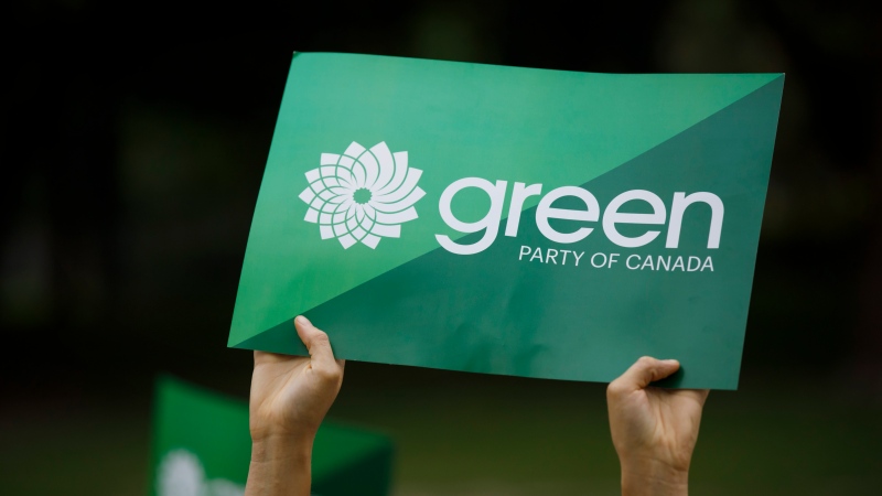 A supporter holds a sign for the Green Party of Canada in Toronto, Tuesday, Sept. 3, 2019. THE CANADIAN PRESS/Cole Burston