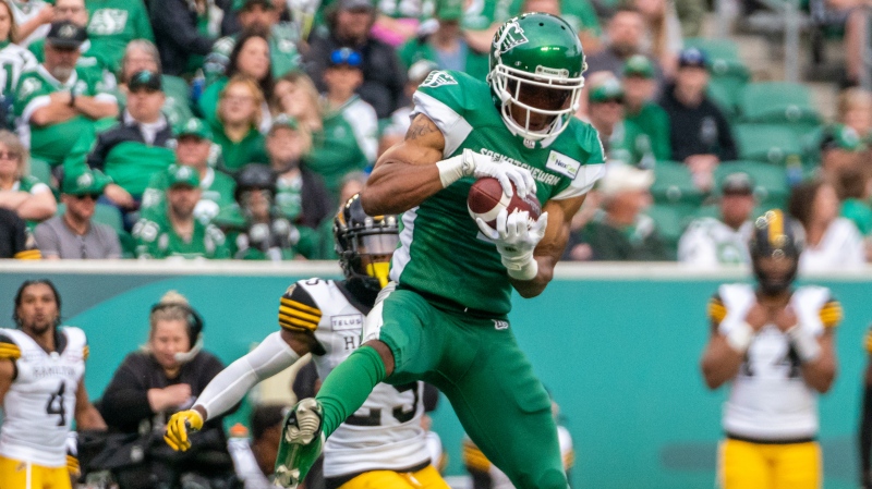 Saskatchewan Roughriders receiver Shaq Evans (1) catches the football against Hamilton Tiger-Cats during second half CFL football action in Regina on Saturday, June 11, 2022. THE CANADIAN PRESS/Heywood Yu 