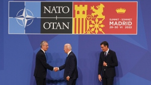 U.S. President Joe Biden, centre is greeted by NATO Secretary General Jens Stoltenberg, left and Prime Minister Pedro Sanchez of Spain, at the NATO summit in Madrid, Spain, on June 29, 2022. (Kenny Holston / Pool Photo via AP) 