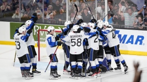 Members of the Saint John Sea Dogs celebrate their win over the Shawinigan Cataractes during Memorial Cup hockey action in Saint John, N.B. on Saturday, June 25, 2022. (THE CANADIAN PRESS/Darren Calabrese)