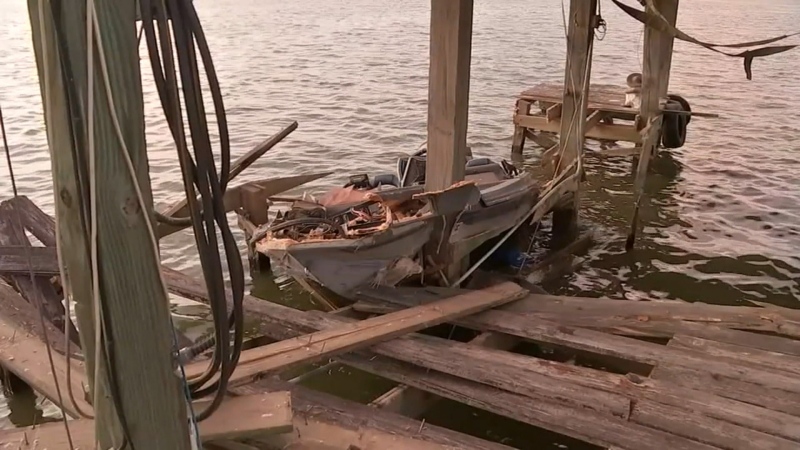 This still from a video shows a boat after it crashed head-on into a dock on a Texas lake.