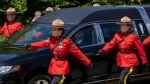 RCMP members escort the hearse at a regimental memorial service for Const. Heidi Stevenson in Dartmouth, N.S., on Wednesday, June 29, 2022. (THE CANADIAN PRESS/Andrew Vaughan)