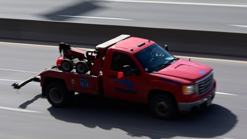 A tow truck drives along the Don Valley Parkway in Toronto on Tuesday, March 2, 2021. THE CANADIAN PRESS/Frank Gunn