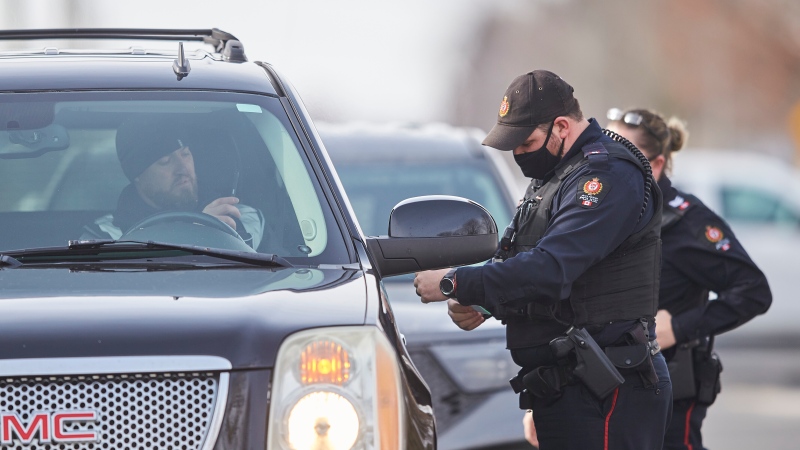 Police perform a traffic stop in Aylmer, Ont. on Sunday, January 31, 2021  THE CANADIAN PRESS/Geoff Robins