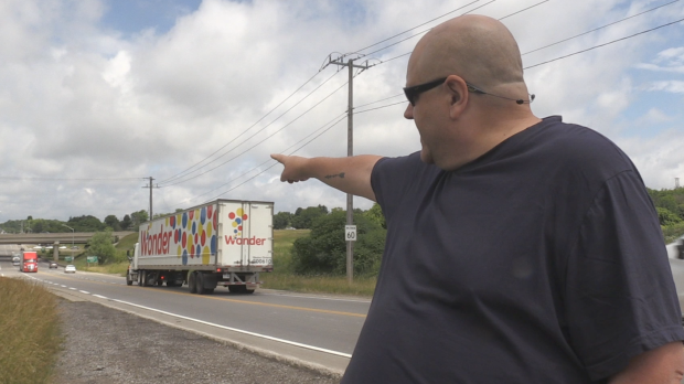 Patrick Anderson points to the Highway 7/8 ramps on Ira Needles Blvd. where he would like to see traffic lights installed. (Carmen Wong/ CTV Kitchener)