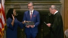 In this image from video provided by the U.S. Supreme Court, Chief Justice of the United States John Roberts administers the Constitutional Oath to Ketanji Brown Jackson as her husband Patrick Jackson holds the Bible at the Supreme Court in Washington, Thursday, June 30, 2022. (Supreme Court via AP)