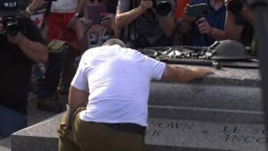 Canadian Forces veteran James Topp drops to one knee at the Tomb of the Unknown Soldier after completing his cross-Canada march to protest vaccine mandates. (Tyler Fleming/CTV News Ottawa)