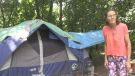Christine Woodley stands outside the tent she lives in. (Carmen Wong/ CTV Kitchener)