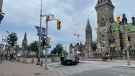 Two police officers monitor Wellington Street as people arrive in downtown Ottawa on Canada Day. (Josh Pringle/CTV News Ottawa)