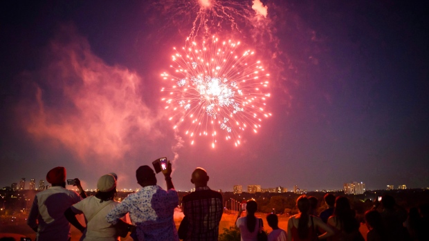 People watch a fireworks show in Centennial park as part of Canada Day celebrations, in Toronto on Sunday, July 1, 2018. THE CANADIAN PRESS/Christopher Katsarov 