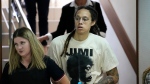 WNBA star and two-time Olympic gold medalist Brittney Griner is escorted to a courtroom for a hearing, in Khimki just outside Moscow, Russia, Friday, July 1, 2022. (AP Photo/Alexander Zemlianichenko)