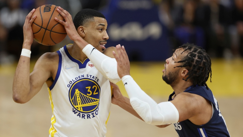Golden State Warriors forward Otto Porter Jr. (32) is defended by Dallas Mavericks guard Jalen Brunson during the second half of Game 2 of the NBA basketball playoffs Western Conference finals in San Francisco, Friday, May 20, 2022. (AP Photo/Jed Jacobsohn)