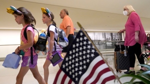 Airline passengers arrive at Chicago's Midway International Airport on the first day of the July 4th holiday weekend Friday, July 1, 2022, in Chicago. (AP Photo/Charles Rex Arbogast)