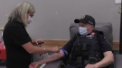 A member of the Waterloo Regional Police Service making a donation to Canadian Blood Services. (Colton Wiens/CTV Kitchener)