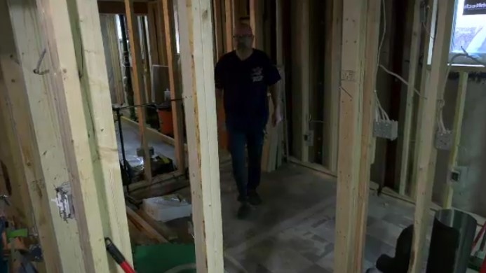 Ryan Kirkness in his basement amid stalled renovations.