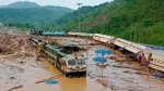 Train coaches are seen toppled over following mudslides triggered by heavy rains at New Haflong railway station on the Lumding-Silchar route at Dima Hasao district, in northeastern Assam state, India, Tuesday, May 16, 2022. (AP Photo)