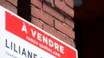 A sign advertising the sale of a house is shown in Montreal, March 4, 2022. THE CANADIAN PRESS/Graham Hughes