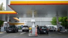 People fuel up vehicles at a Shell gas station in Vancouver, on Saturday, May 14, 2022. THE CANADIAN PRESS/Darryl Dyck