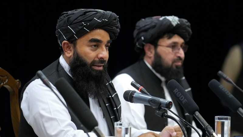 Zabiullah Mujahid, left, the spokesman for the Taliban government, speaks during a press conference in Kabul, Afghanistan, Thursday, June 30, 2022. (AP Photo/Ebrahim Noroozi)