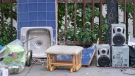 Discarded belongings are shown on a street on moving day in Montreal, Friday, July 1, 2022. THE CANADIAN PRESS/Graham Hughes