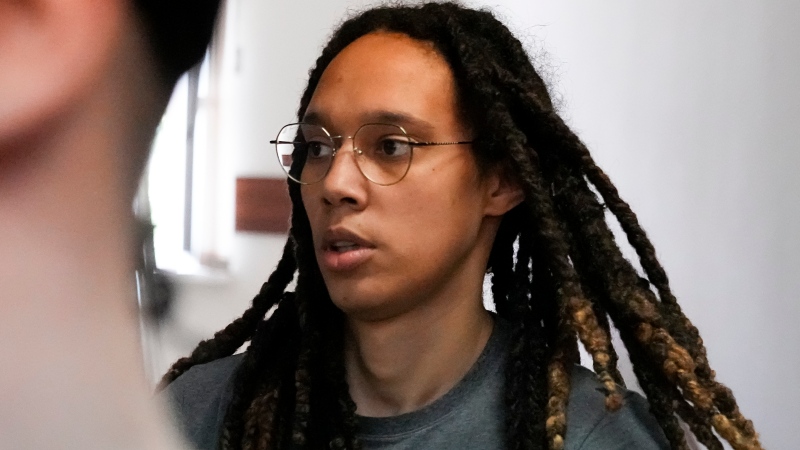WNBA star and two-time Olympic gold medalist Brittney Griner is escorted to a courtroom for a hearing, in Khimki just outside Moscow, Russia, Monday, June 27, 2022. More than four months after she was arrested at a Moscow airport for cannabis possession, American basketball star Brittney Griner appeared in court Monday for a preliminary hearing ahead of her trial. (AP Photo/Alexander Zemlianichenko)