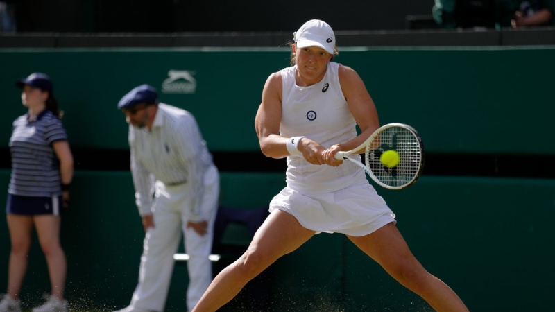 Poland's Iga Swiatek returns the ball to France's Alize Cornet during a third round women's singles match on Day 6 of the Wimbledon tennis championships in London, July 2, 2022. (AP Photo/Kirsty Wigglesworth)