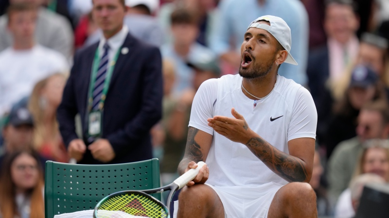 Australia's Nick Kyrgios complains to the umpire about a line call after losing a point to Greece's Stefanos Tsitsipas during a third round men's singles match on day six of the Wimbledon tennis championships in London on July 2, 2022. (AP Photo/Kirsty Wigglesworth)