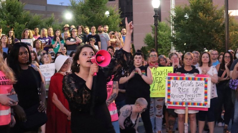 Women's Health Center of West Virginia's executive director, Katie Quinonez, speaks to a crowd at a vigil outside the Robert C. Byrd federal Courthouse in Charleston, W.Va. on June 24, 2022. The Women's Health Center, West Virginia's only abortion clinic, had to suspend abortion services after the U.S. Supreme Court's decision because of a state law dating back to the 1800s that makes abortion care a felony. (AP Photo/Leah M. Willingham)