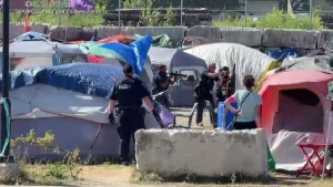 Waterloo regional police were called to the Victoria Street encampment for a disturbance involving a weapon on July 2, 2022. (Still from a video by Edwin Finch)