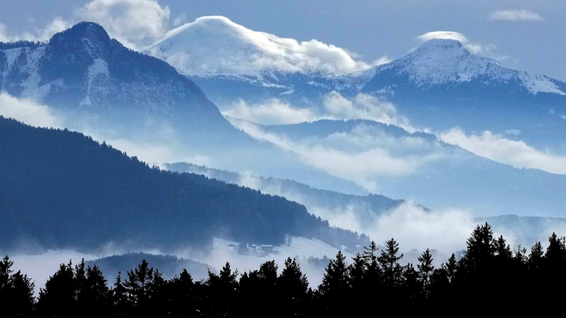 Clouds hang over the snow-covered Dolomites mountains near Bolzano, in northern Italian province of South Tyrol, Italy, Tuesday, Dec. 2, 2021. (AP Photo/Matthias Schrader)
