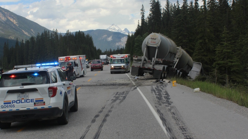 An image of the scene shared by Mounties shows that the semi was hauling two cylindrical tanks. Skid marks can be seen on the roadway, and the truck is off the side of the road. (Golden-Field RCMP)