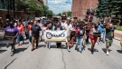 People walk in an NAACP-led march and rally for Jayland Walker, Sunday, July 3, 2022, in Akron, Ohio. (Andrew Dolph/Times Reporter via AP)