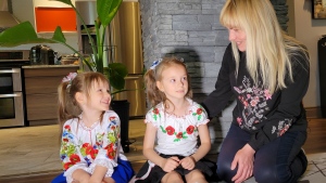 Veronika, Sofiia, and Hanna Kovalenko (right) smile in their new home in Pierrefonds, Que., on June 30, 2022. (CTV NEWS/Bogdan Lytvynenko)