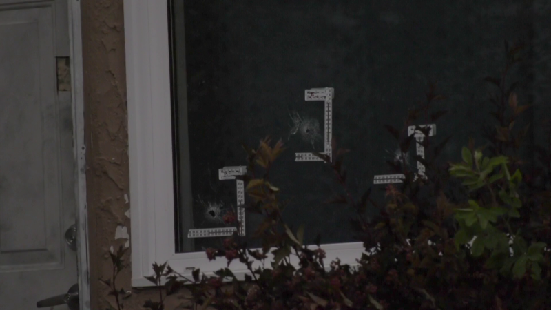 Bullet holes are visible in the window of a home in 200 block of Houde Drive on July 4, 2022. Winnipeg police said a 59-year-old man was killed following a shooting at the home on July 3. (CTV News Winnipeg Photo)