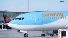 A Sunwing aircraft is parked at Montreal Trudeau airport in Montreal, March 2, 2022. THE CANADIAN PRESS/Paul Chiasson